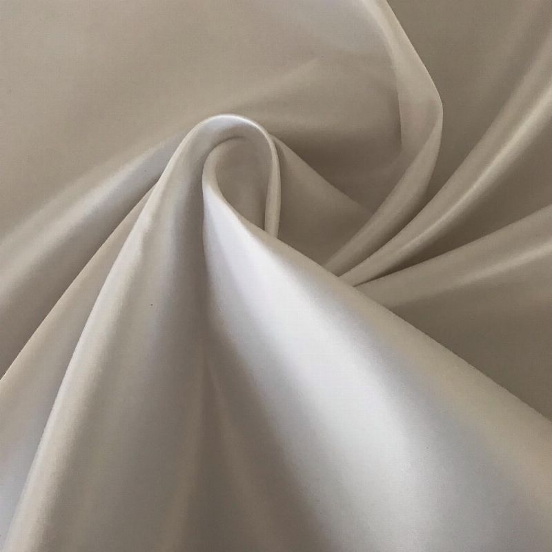 White duchess satin fabric draped in soft folds